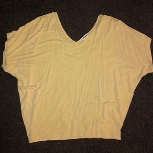 Yellow shirt. Loose fitting.